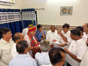 Parliamentary Affairs Minister Jogaram Patel holding a review meeting with administrative officials at the Barmer Circuit House