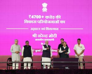 Prime Minister Narendra Modi waving during a public address on national infrastructure development