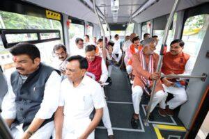 Text: Chief Minister Dr. Mohan Yadav and cabinet ministers traveling in an electric bus to Jagdishpur